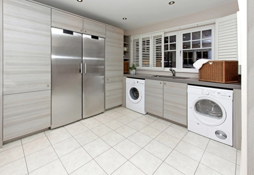 family laundry room with storage closets