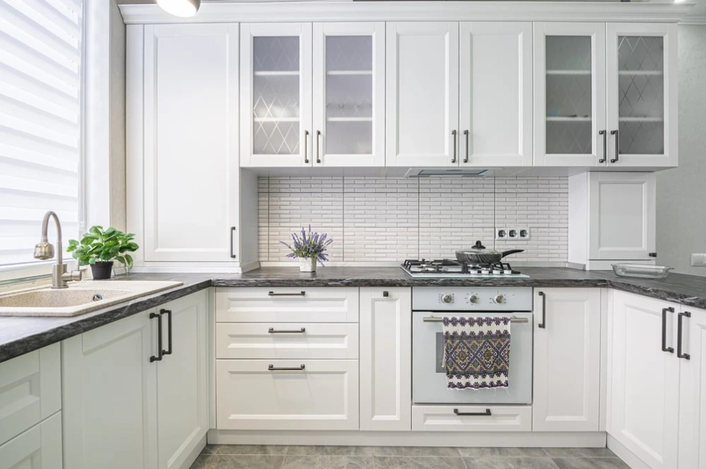 black handles on white recessed cabinet doors