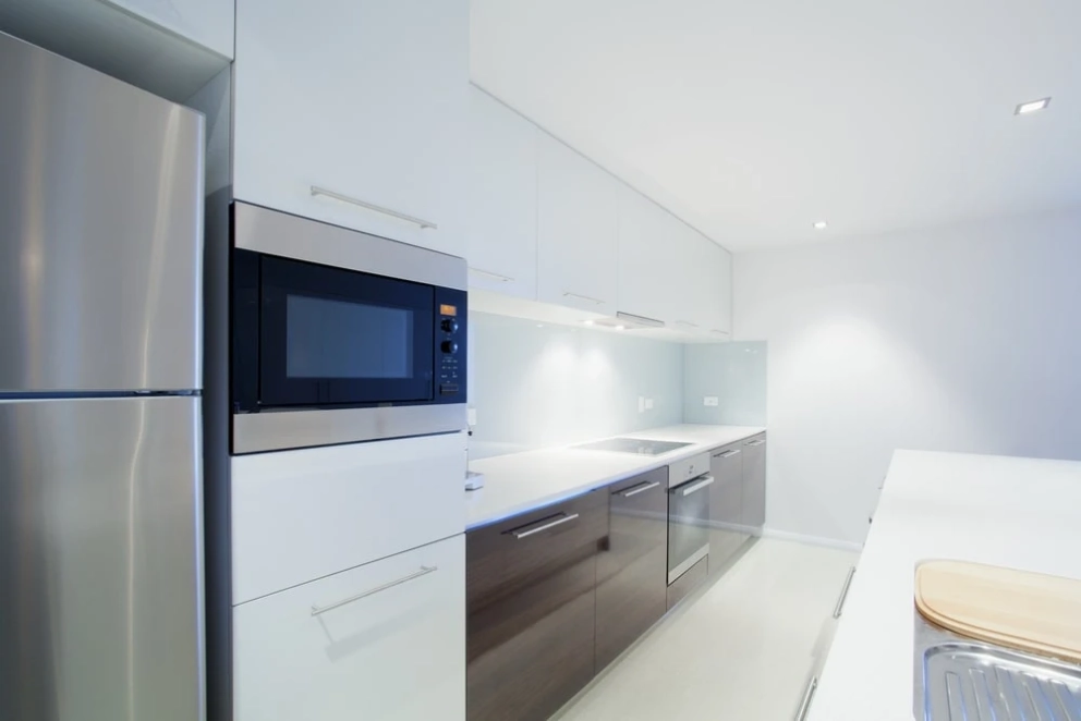 30 inches deep fridge and stove with cabinets behind the fridge and side cabinets