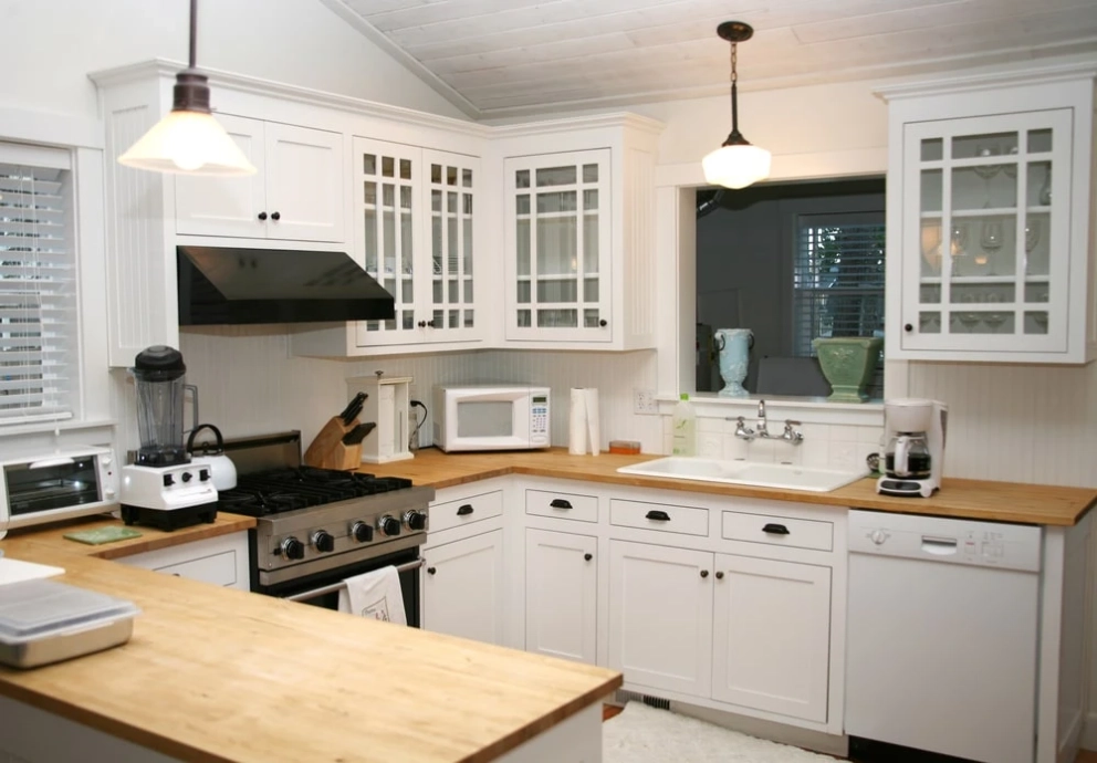 g-shaped kitchen with white cabinets