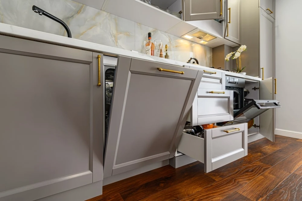 base recessed flat panel kitchen cabinets with golden hardware