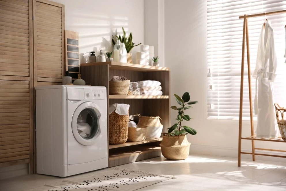 laundry room with cabinets and clothes rack