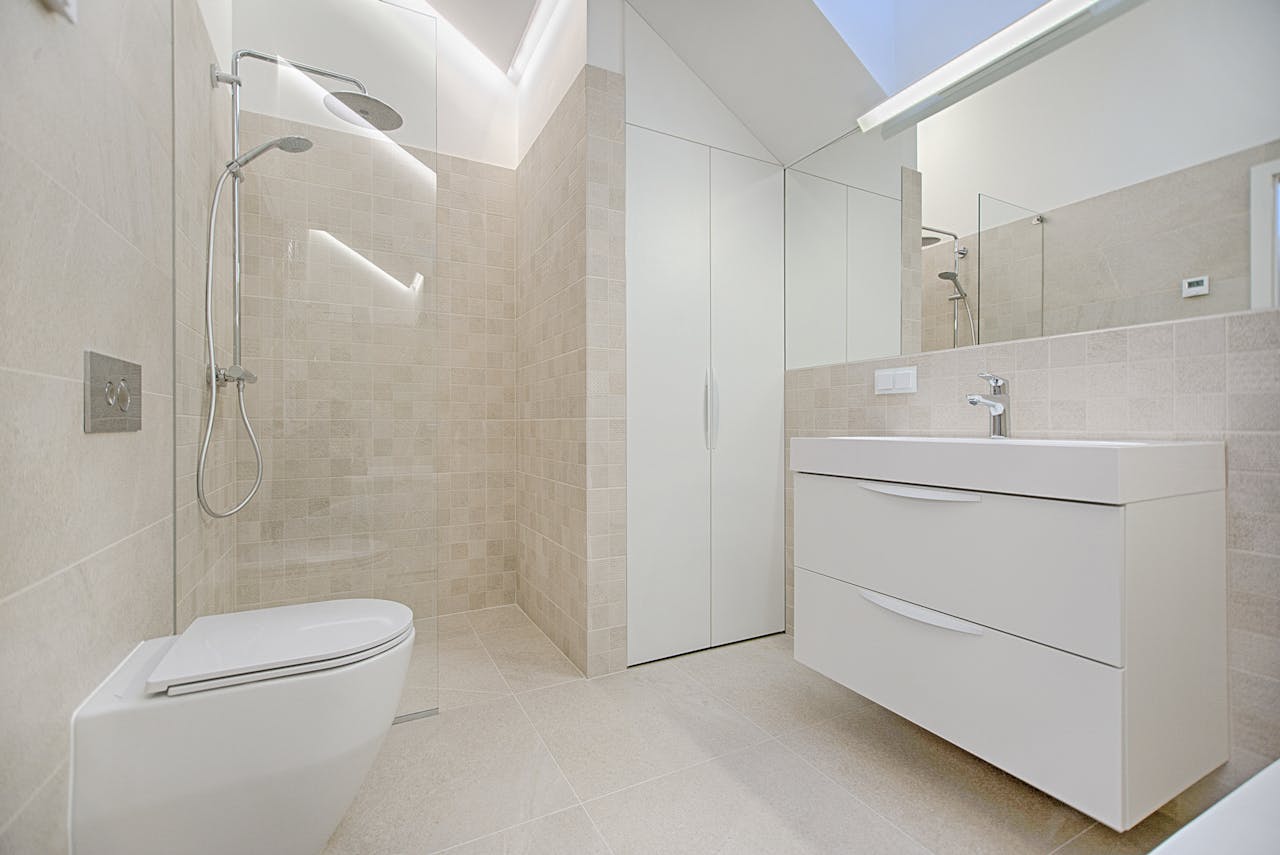 bathroom interior showing clear zoning of shower, toilet, and vanity areas
