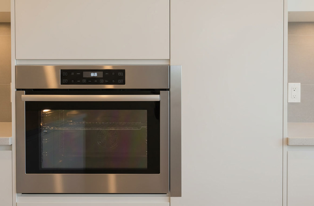 thermofoil kitchen cabinet door installed safely beside an microwave with a heat shield