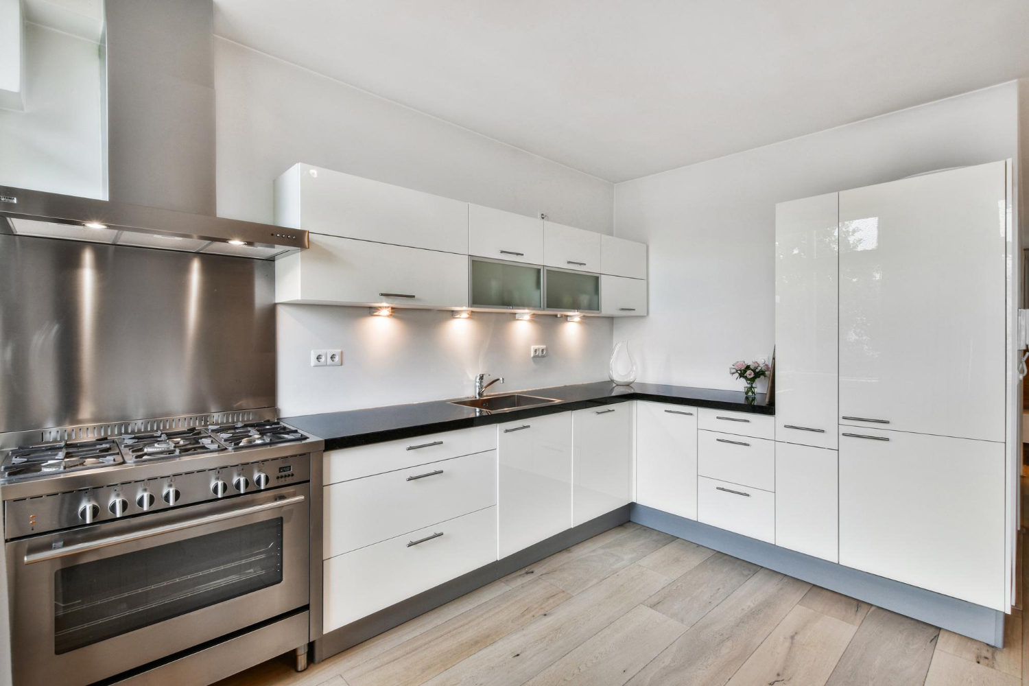 High-gloss white thermofoil kitchen cabinets in a luxury modern kitchen