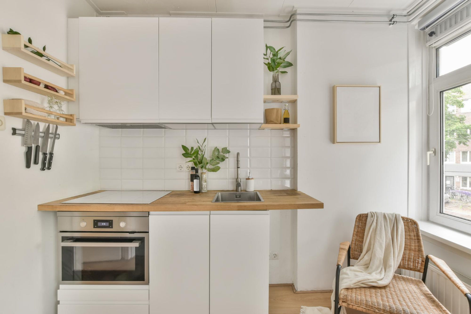 Small kitchen design featuring white thermofoil cabinets with matte finish