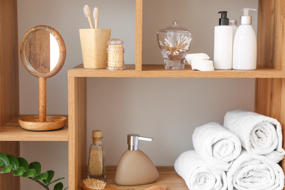 Bathroom wood shelves with toiletries and towels