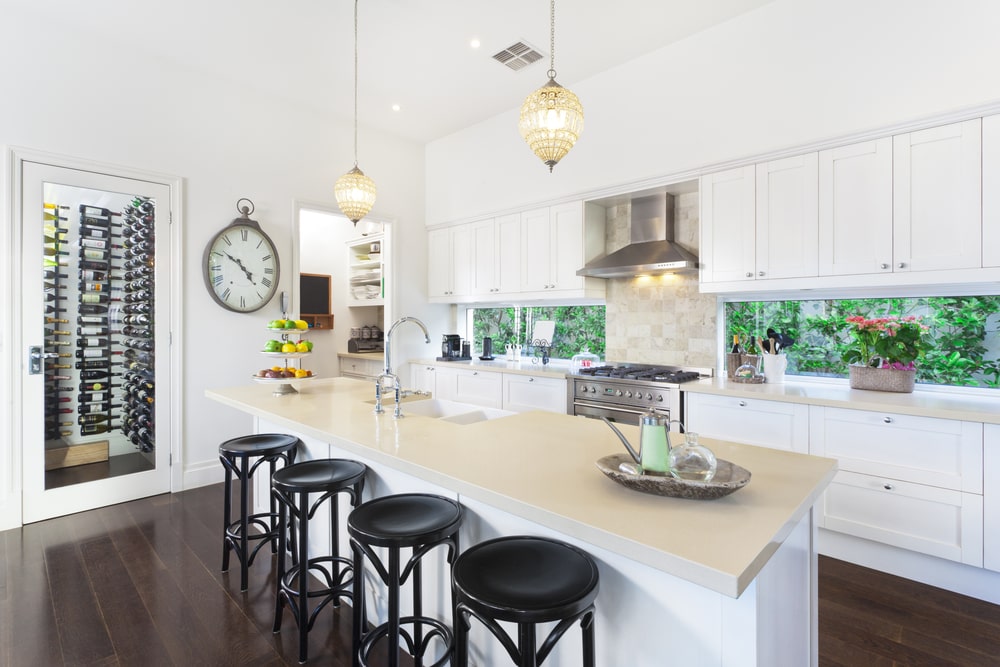White transitional style kitchen with island and shaker cabinets