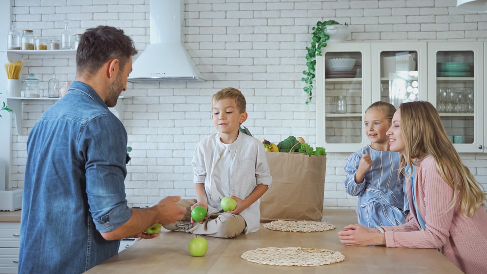 happy family with kids interacts in the kitchen