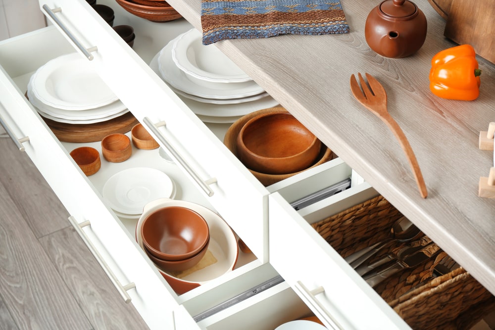 kitchen drawers with lining and dishes inside