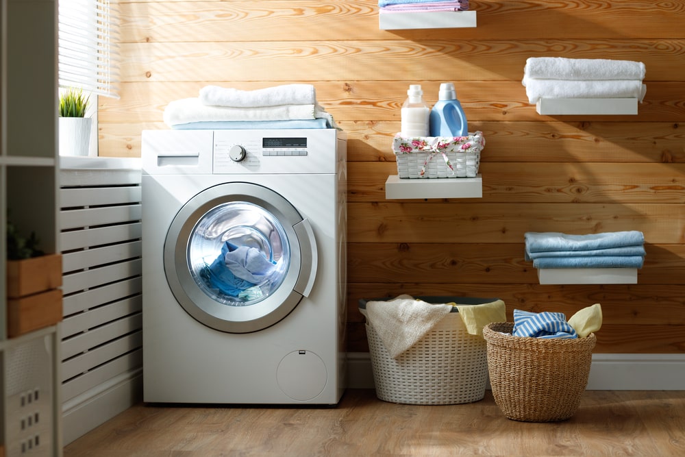 laundry room with floating shelves and baskets