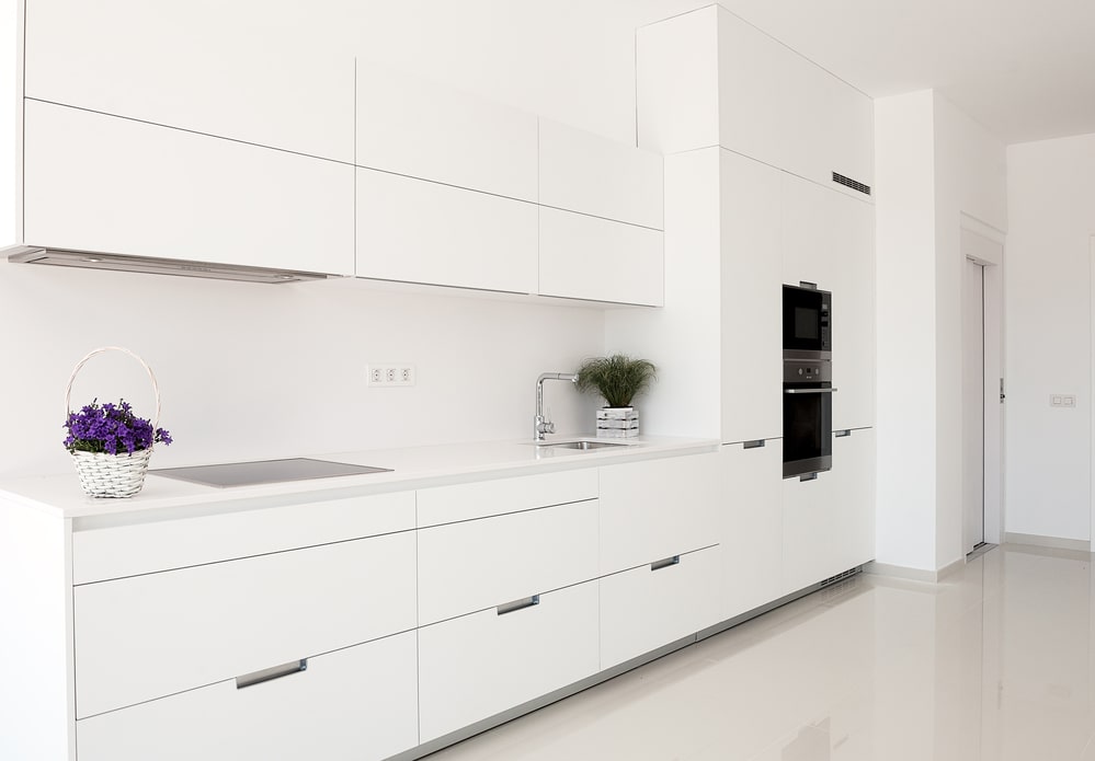 modern white kitchen cabinets with flush pull doors and drawers