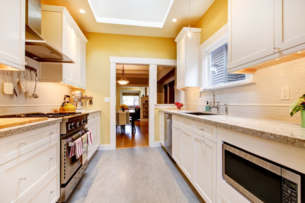 shallow white cabinets in the small galley kitchen