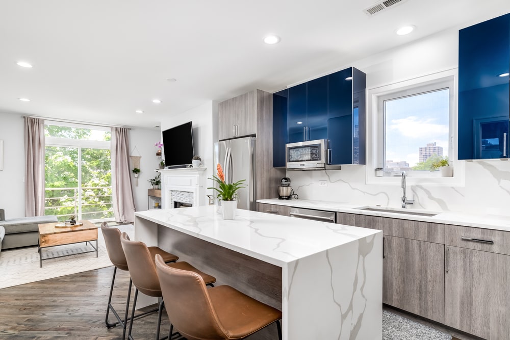 waterfall island with seatings in the open plan kitchen