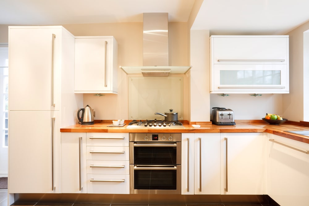 white modular kitchen with wood countertop
