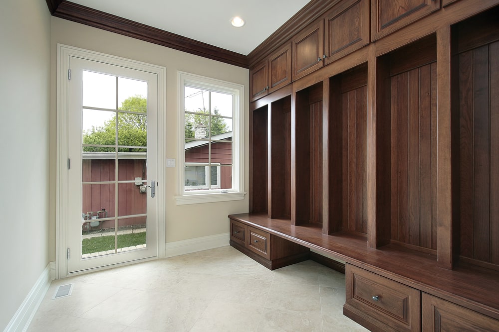 entryway closet with wood cabinets and drawers