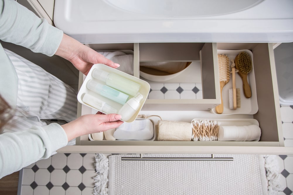 bathroom drawer organizing containers with toiletries