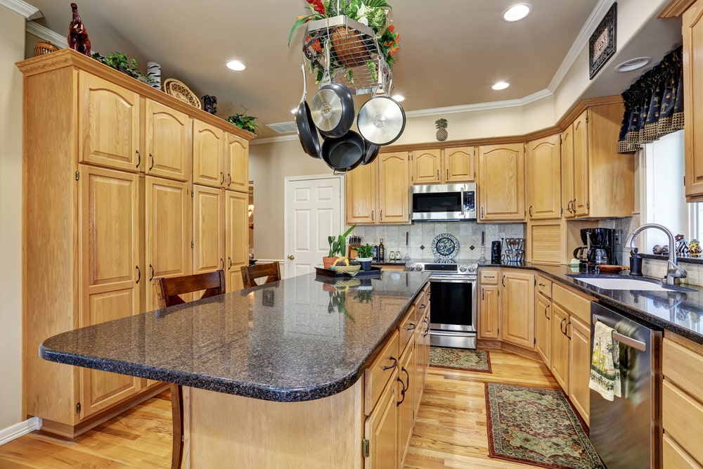 classic kitchen style with arched wall cabinets and granite counters