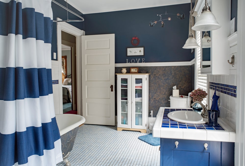 cozy bathroom design with a blue vanity, blue walls and other elements