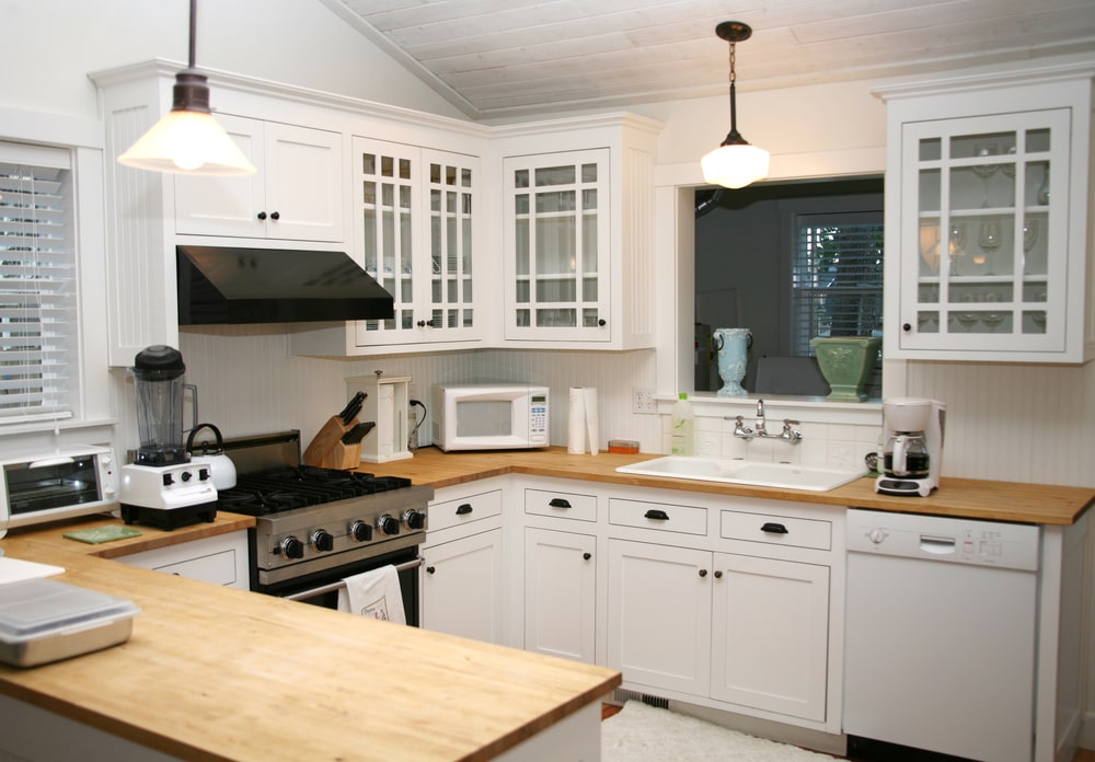g-shaped kitchen with white cabinets
