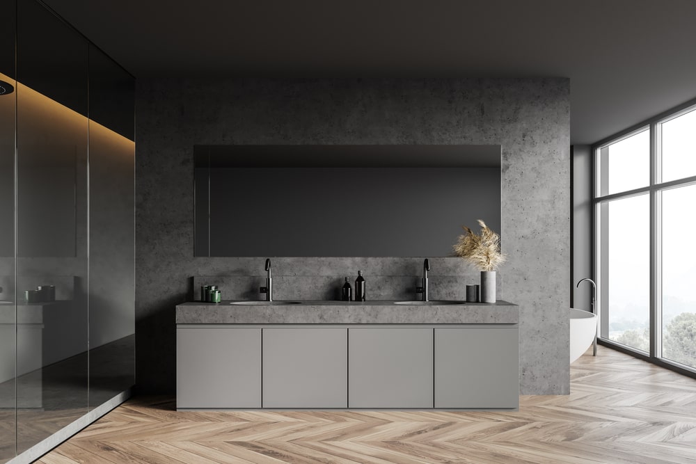 gray concrete bathroom with cabinets