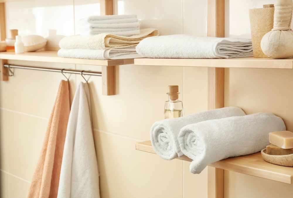 hanging open shelves with towel rack in the bathroom