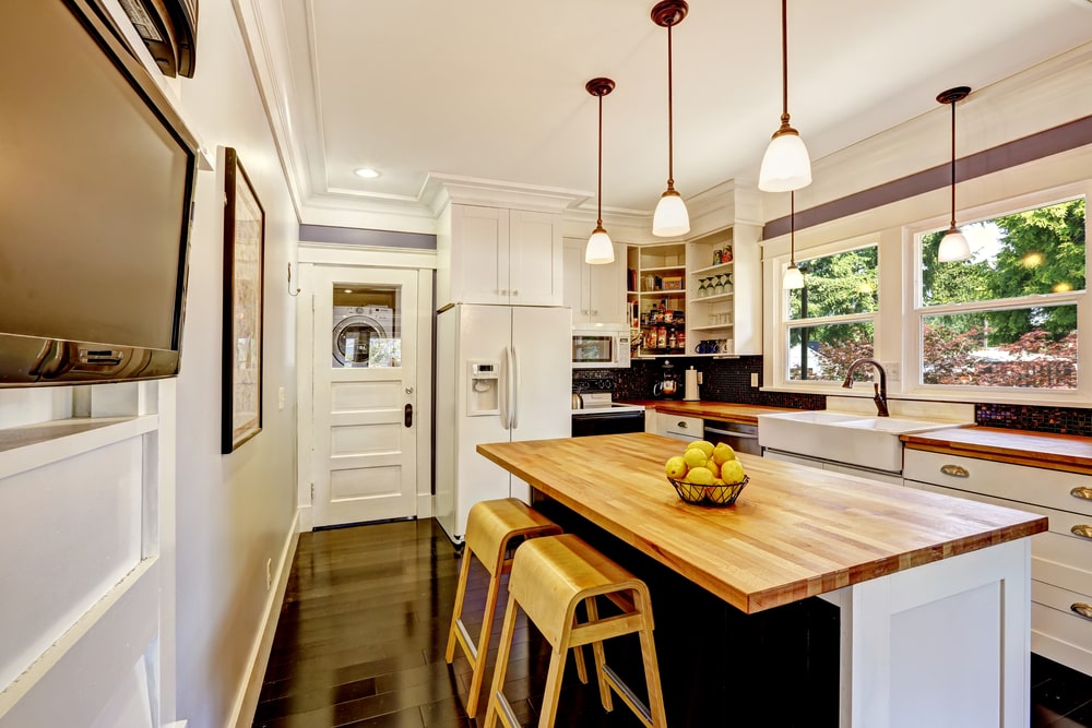 island with seatings in the kitchen with wide path to cabinets and drawers