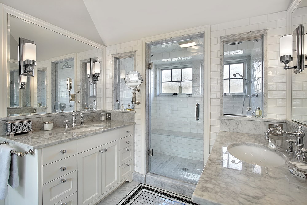 master bathroom with two shaker vanities and marble countertops