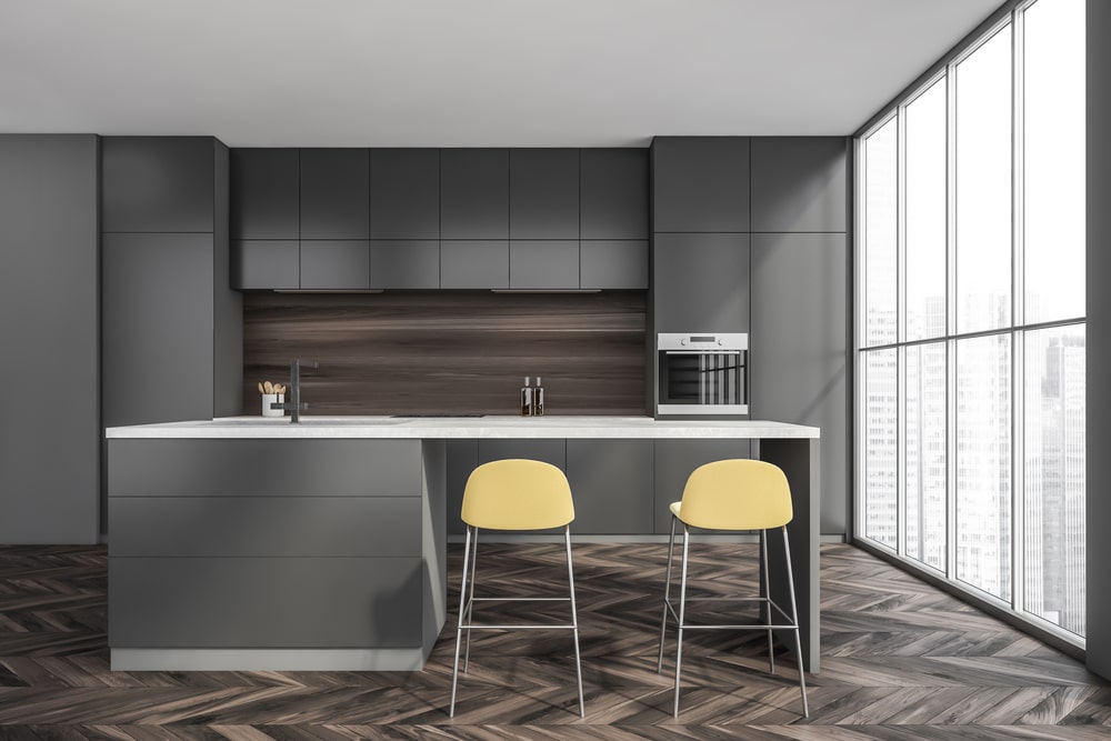 modern grey kitchen with island and dark wood floor