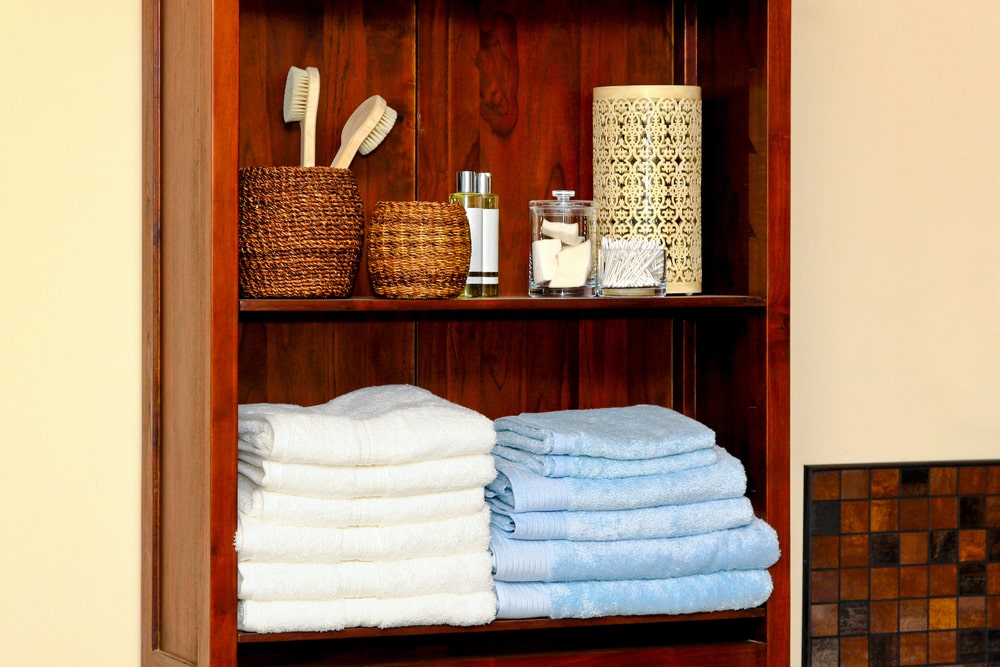shallow bathroom shelf with towels and accessories