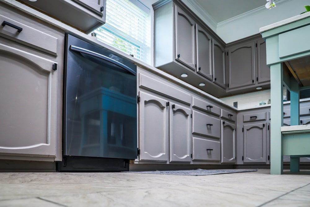Grey double arch door cabinets and black appliance