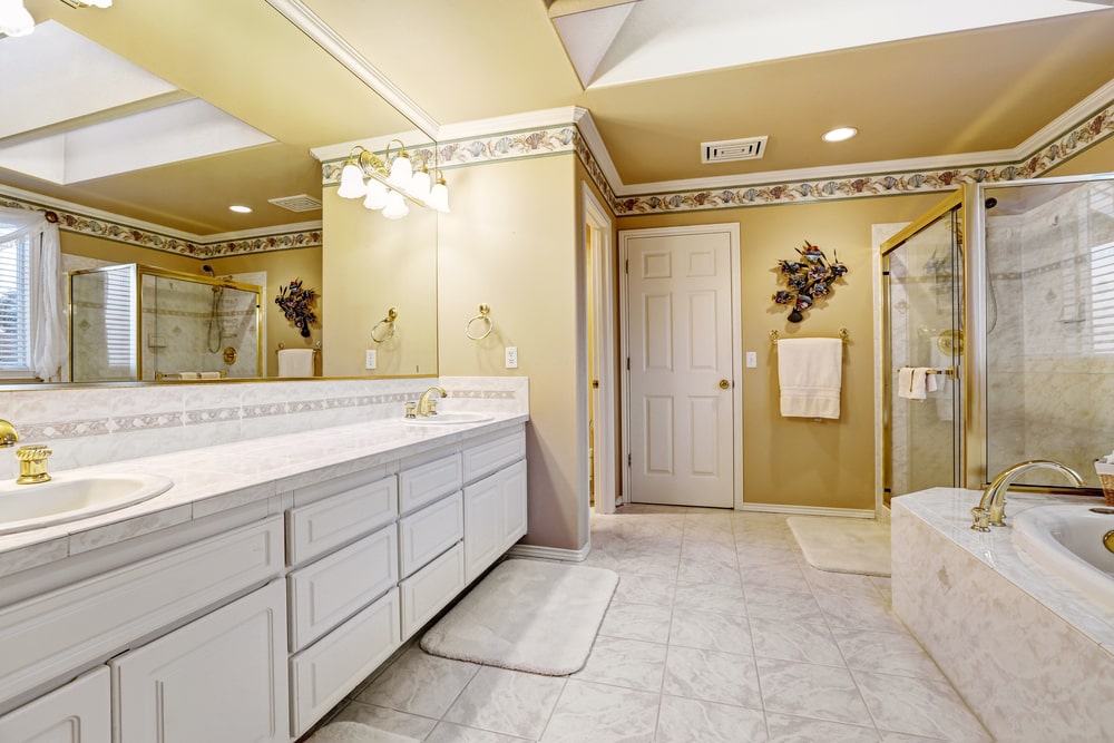 built-in white vanity with large mirror and vanity lighting