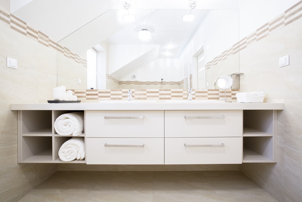 fitted bathroom vanity with drawers and shelves for storage