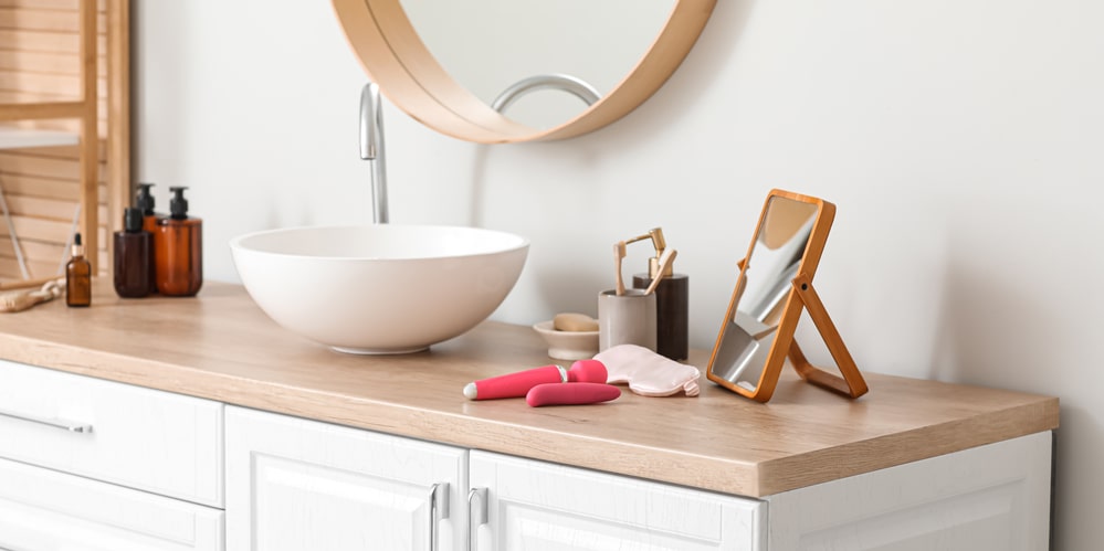 round mirror and bathroom tools on the vanity countertop