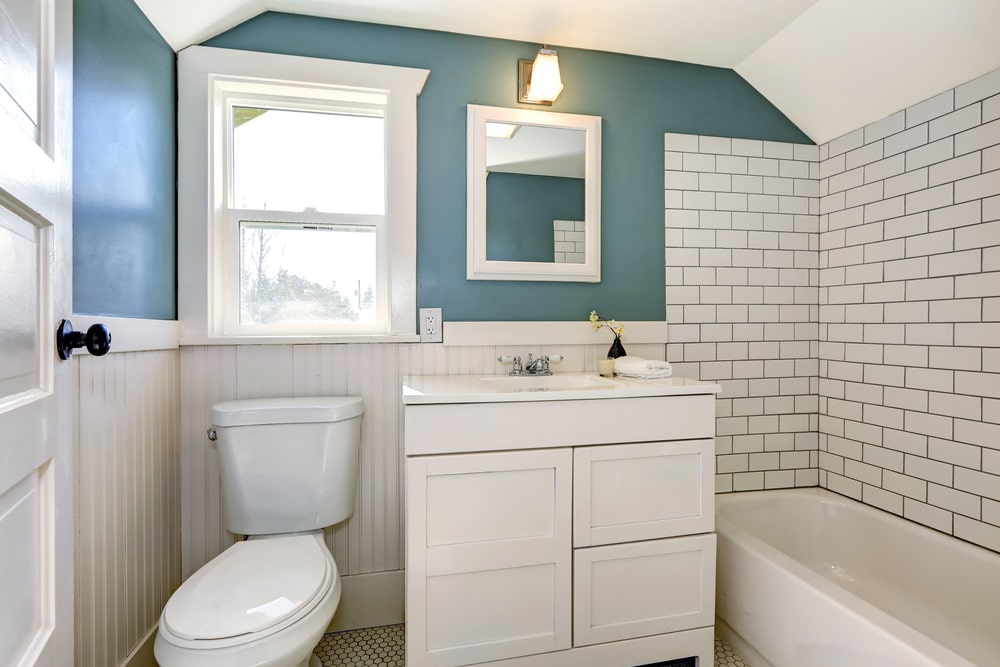 undermount sink vanity with drawers in the white and blue bathroom