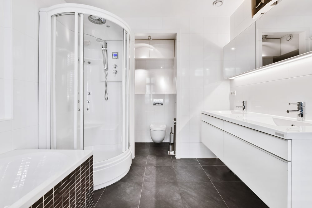 white bathroom with over the toilet storage cabinets
