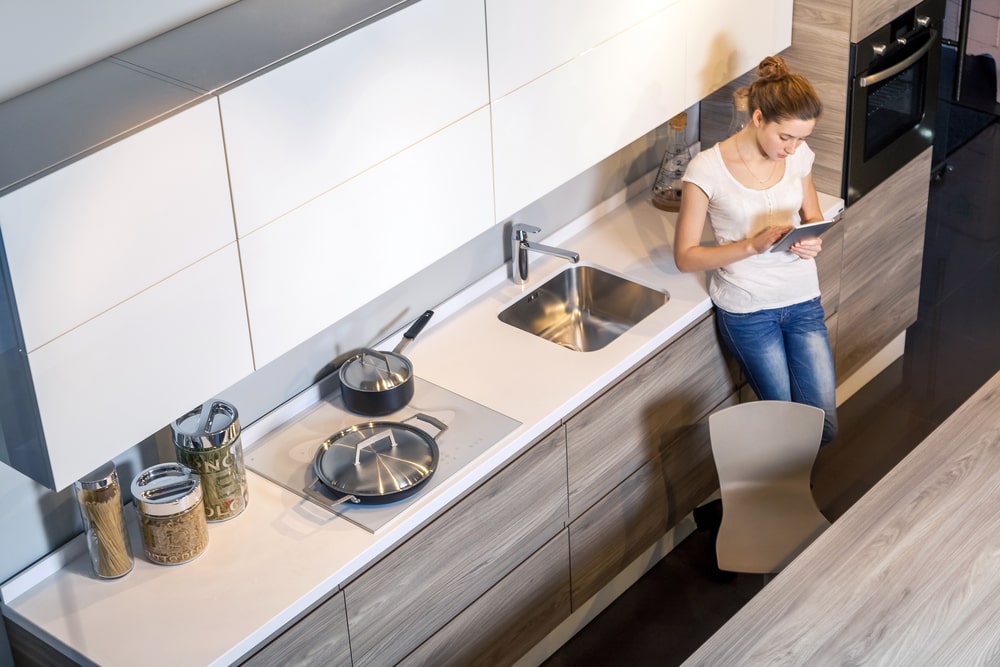 a person is using a tablet to control their smart kitchen appliances