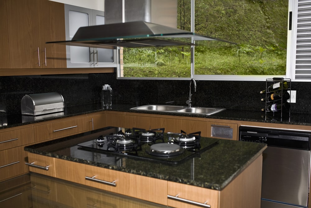 dark gemstone countertop with cooktop in the kitchen