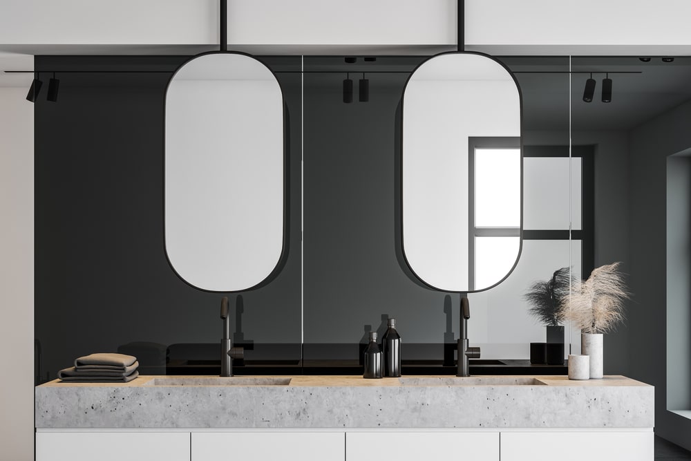 double sink with mirror modern design, black backsplash and concrete countertop