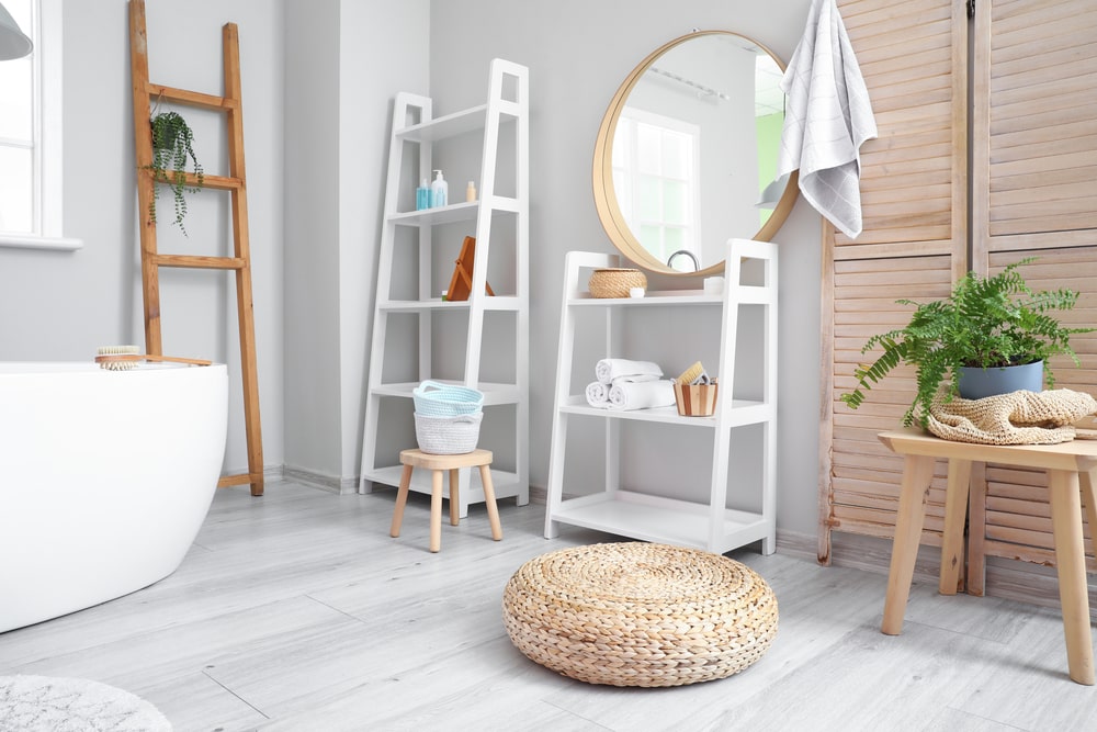 bathroom with ladder shelves and various items on them
