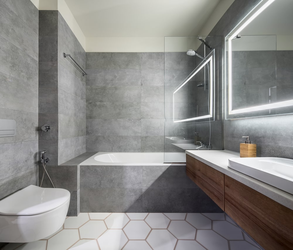 designer bathroom with bathtub and floating vanity