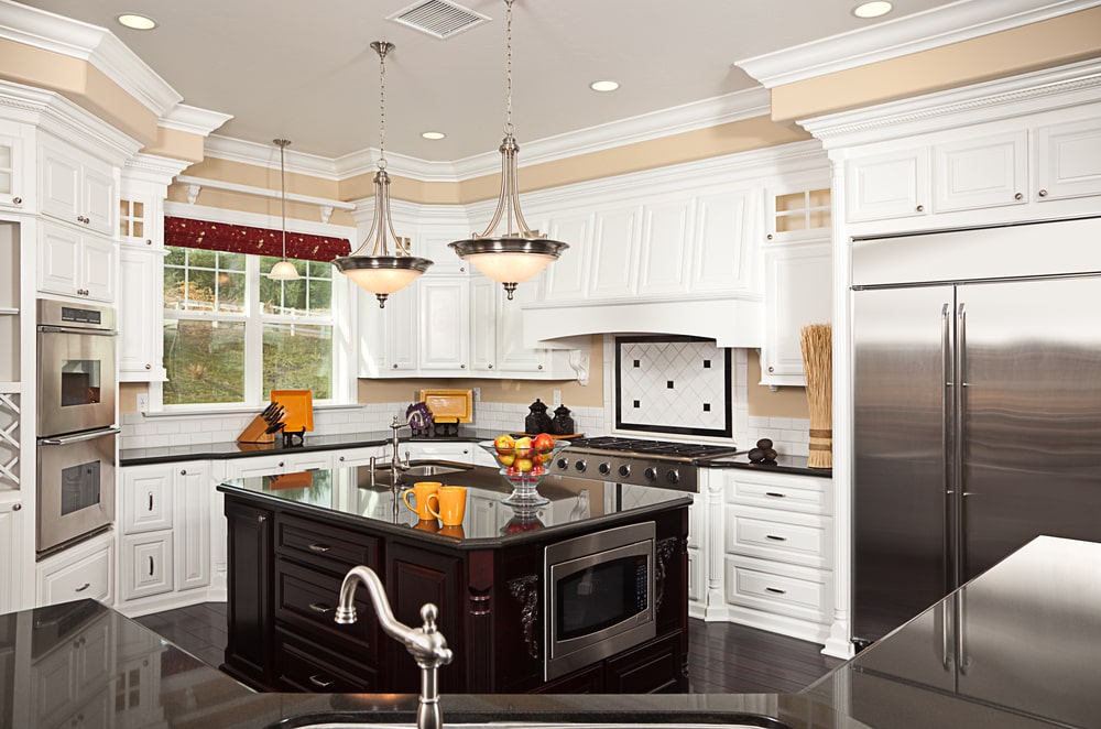 g-shaped kitchen white cabinets and black countertop
