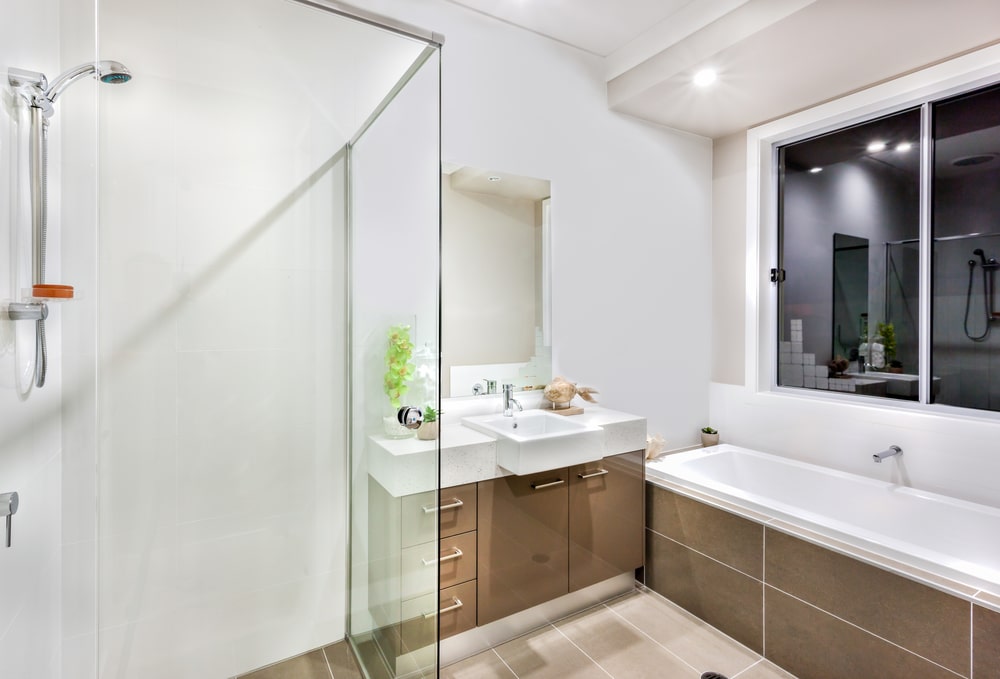 glossy slimline vanity cabinets and mirror in the bathroom