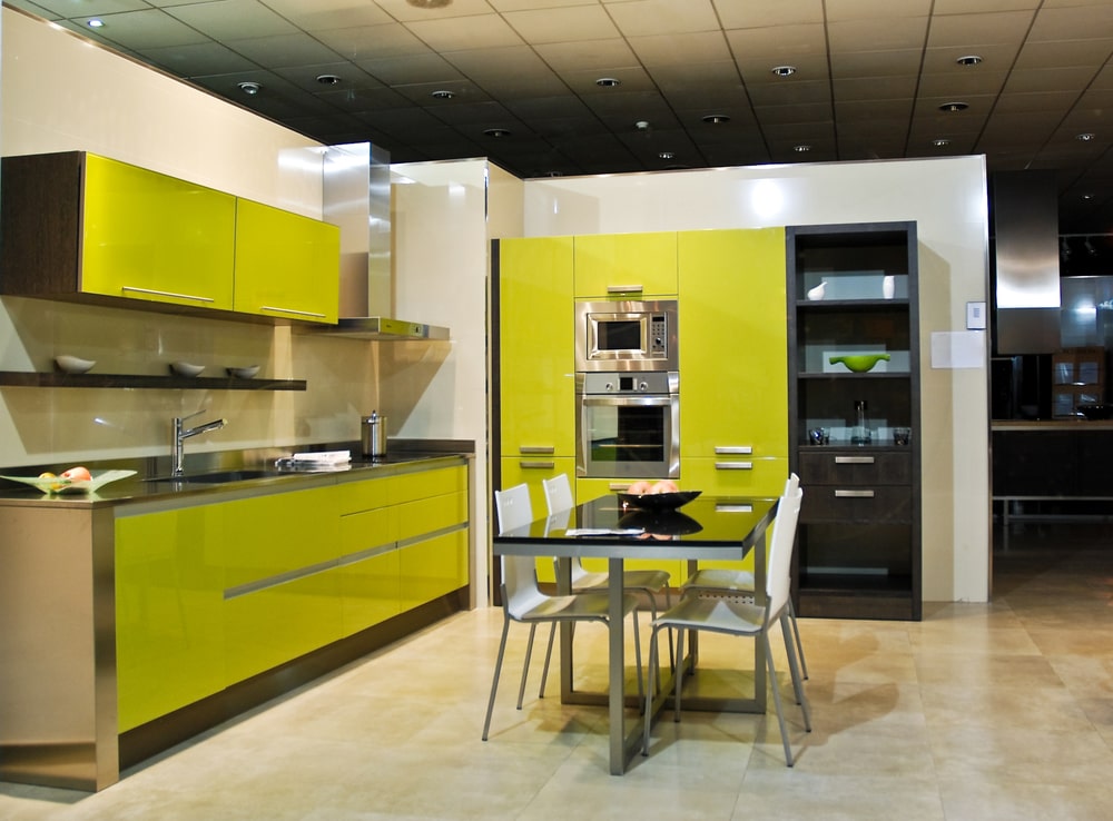 two-tone sage green with glossy black kitchen cabinets