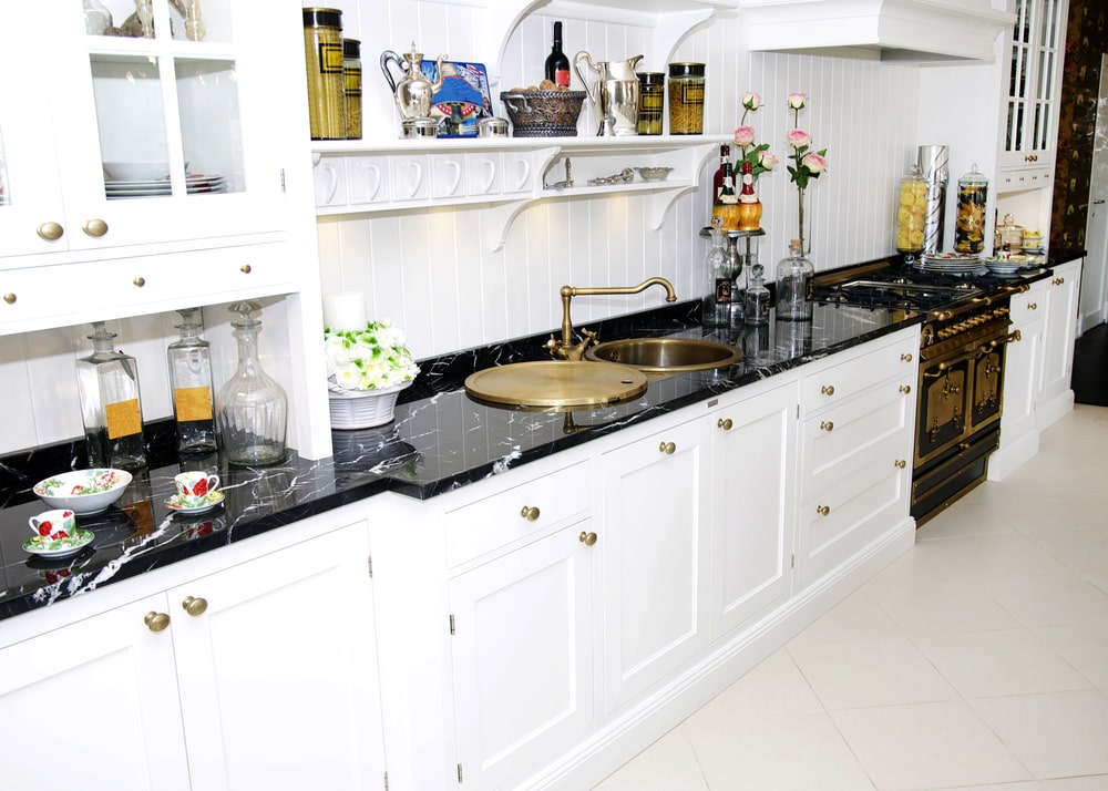 kitchen with white cabinets, gold knobs and matching hinges