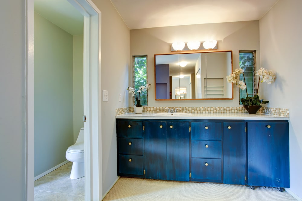 The navy blue vanity cabinet as a focal point in the bathroom