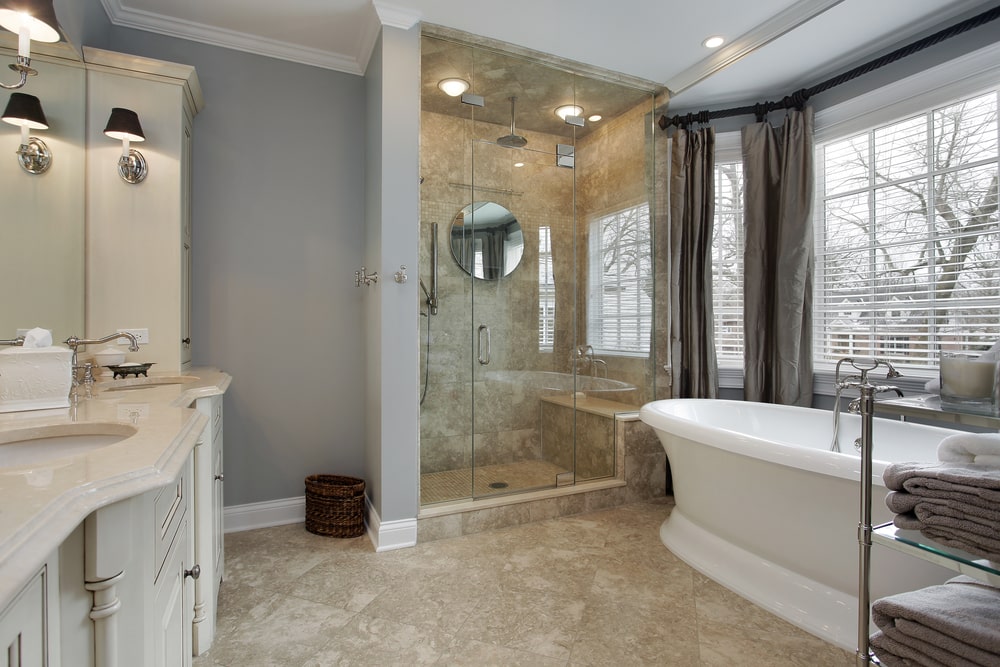 large bathroom with marble counter and gray painted walls