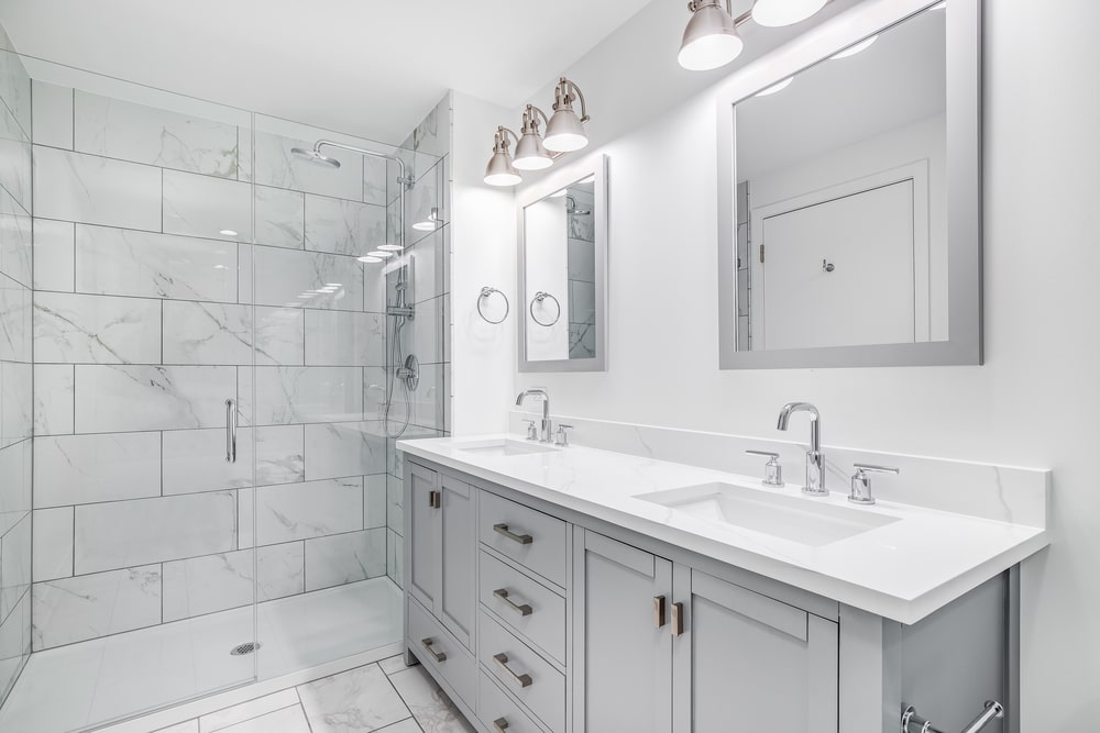 light grey shaker vanity cabinet and mirror frame in white bathroom interior