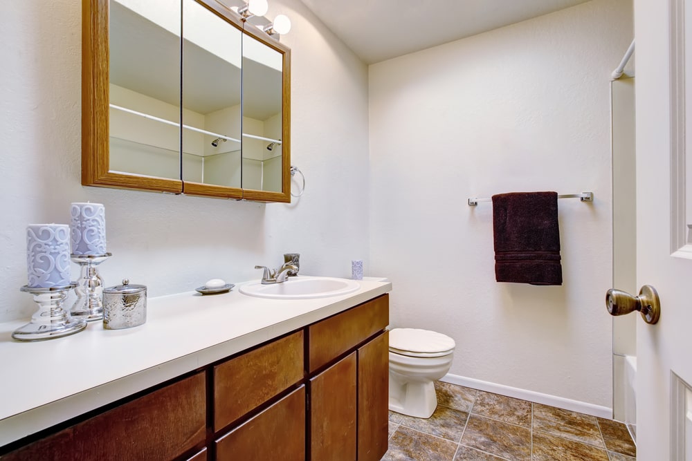 small bathroom in the basement with toilet and vanity