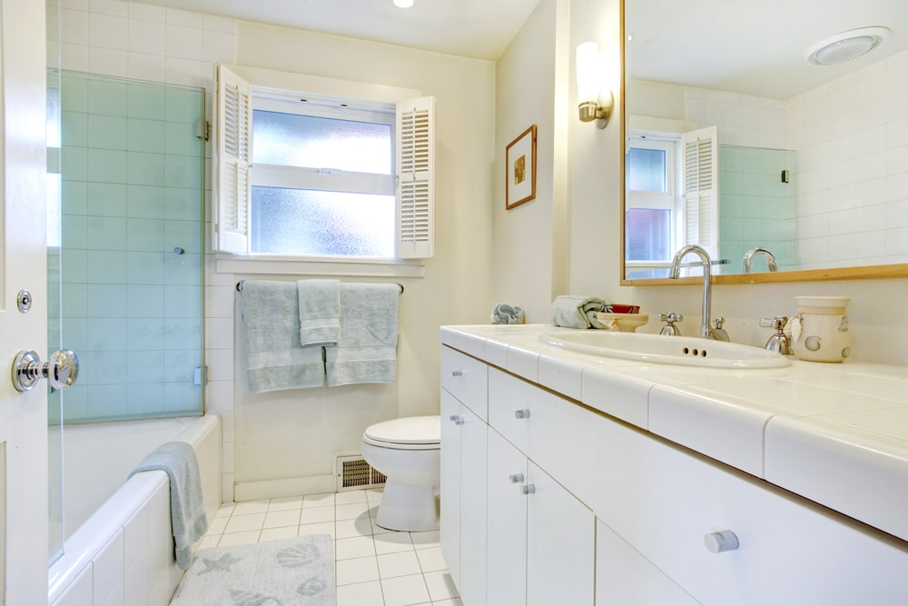 white bathroom vanity with white marble countertop